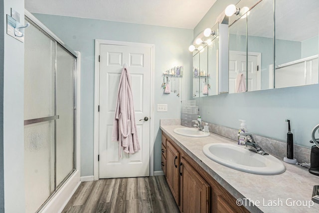 2851 18 Mile Rd, Kent City, MI 49330 - full bath featuring a shower with shower door, wood finished floors, and double vanity