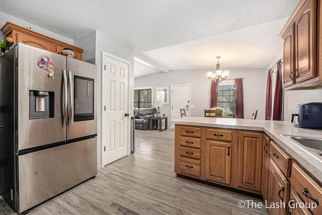 2851 18 Mile Rd, Kent City, MI 49330 - kitchen featuring stainless steel fridge, a peninsula, light wood-style flooring, lofted ceiling, and plenty of natural light
