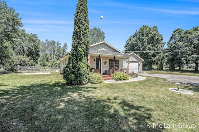 2851 18 Mile Rd, Kent City, MI 49330 - bungalow featuring a porch, driveway, and a garage