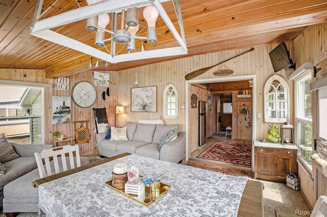 636 Swains Lake Dr, Concord, MI 49237 - living room featuring wood walls, healthy amount of natural light, a wood ceiling with exposed beams, and a chandelier