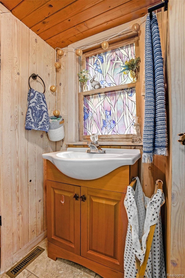 636 Swains Lake Dr, Concord, MI 49237 - bathroom with vanity, wood ceiling, and wooden walls