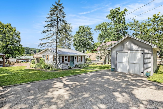 636 Swains Lake Dr, Concord, MI 49237 - view of front facade featuring an outdoor structure, a front yard, driveway, and a metal roof