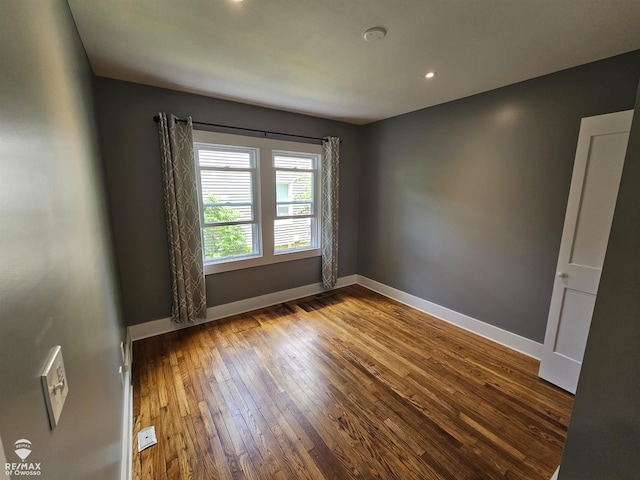 624 E Comstock St, Owosso, MI 48867 - spare room featuring hardwood / wood-style flooring and recessed lighting