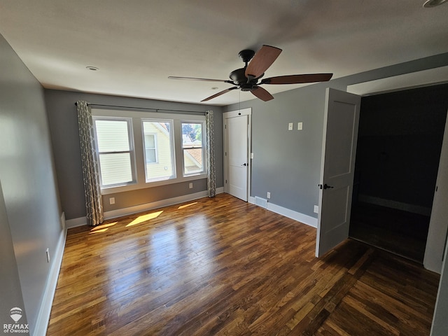 624 E Comstock St, Owosso, MI 48867 - unfurnished bedroom featuring dark wood-style floors and ceiling fan