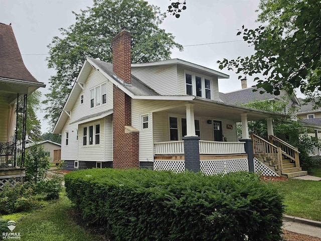 624 E Comstock St, Owosso, MI 48867 - view of front of home featuring a porch and a chimney