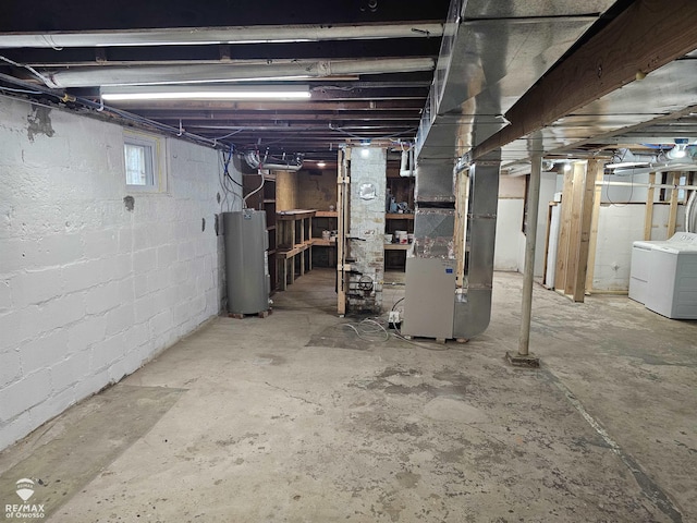 624 E Comstock St, Owosso, MI 48867 - basement with water heater, washing machine and dryer, and heating unit