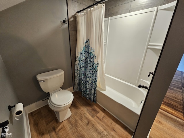 624 E Comstock St, Owosso, MI 48867 - bathroom with shower / bath combination with curtain and wood finished floors