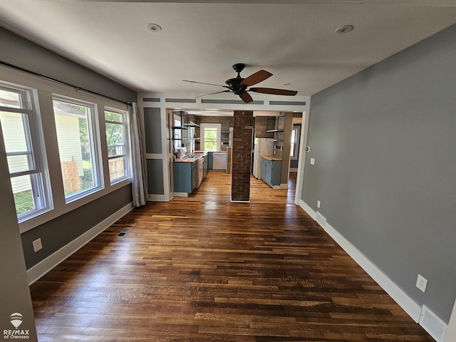 624 E Comstock St, Owosso, MI 48867 - unfurnished living room with plenty of natural light, dark wood-style floors, and ceiling fan