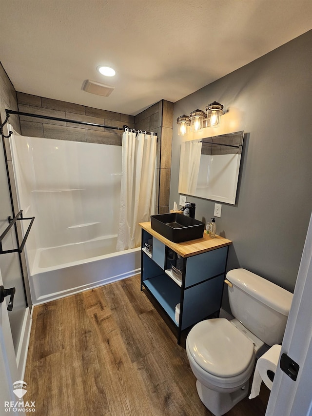 624 E Comstock St, Owosso, MI 48867 - full bath with wood finished floors, shower / bath combo, and vanity