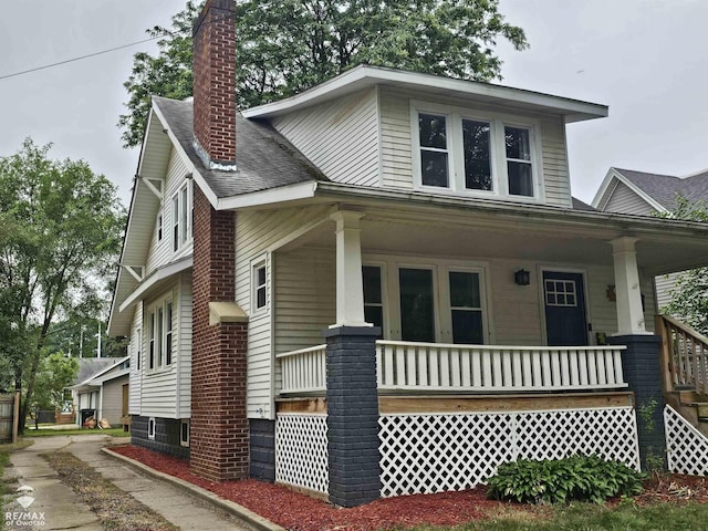 624 E Comstock St, Owosso, MI 48867 - view of front of home featuring a porch and a chimney