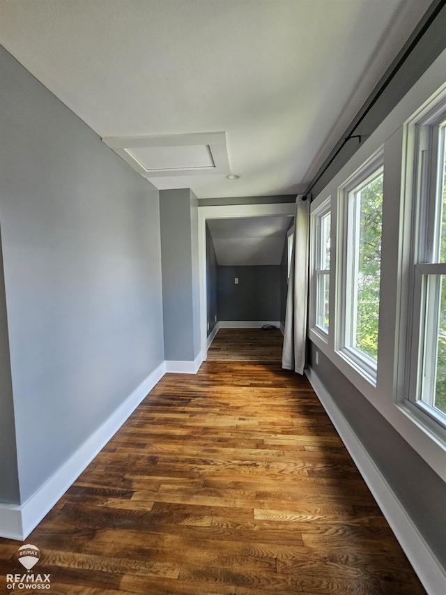 624 E Comstock St, Owosso, MI 48867 - hallway with attic access, wood finished floors, and plenty of natural light
