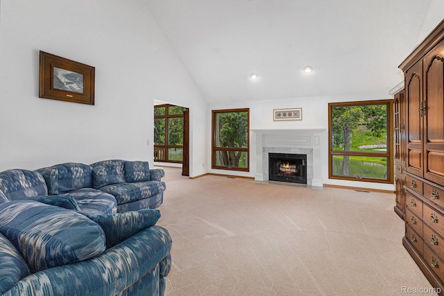 6512 White Lake Rd, Clarkston, MI 48346 - living room featuring light colored carpet, recessed lighting, a high end fireplace, and high vaulted ceiling