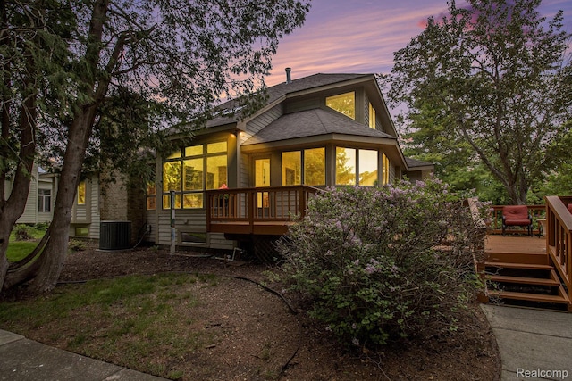 6512 White Lake Rd, Clarkston, MI 48346 - view of front of property with a sunroom, a wooden deck, and a shingled roof