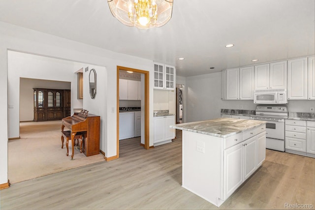 6512 White Lake Rd, Clarkston, MI 48346 - kitchen featuring white appliances, light wood-style flooring, white cabinets, a chandelier, and recessed lighting