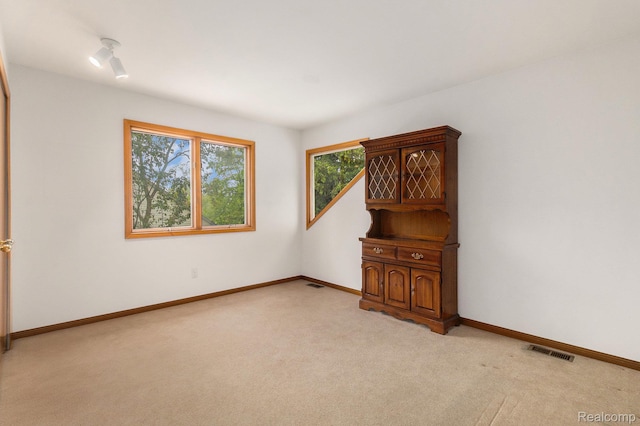 6512 White Lake Rd, Clarkston, MI 48346 - spare room featuring light colored carpet and baseboards