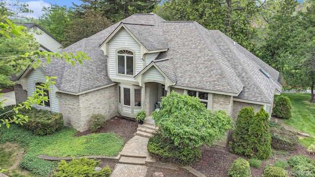 6512 White Lake Rd, Clarkston, MI 48346 - view of front of house featuring brick siding and roof with shingles