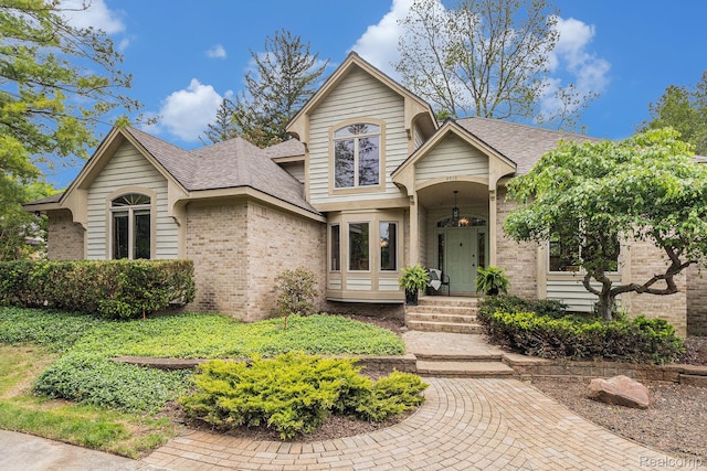 6512 White Lake Rd, Clarkston, MI 48346 - view of front of house featuring brick siding and roof with shingles