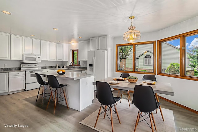 6512 White Lake Rd, Clarkston, MI 48346 - kitchen with white appliances, plenty of natural light, a center island, and recessed lighting