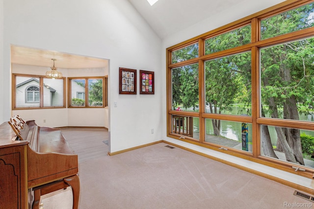 6512 White Lake Rd, Clarkston, MI 48346 - unfurnished living room with a chandelier, carpet flooring, and high vaulted ceiling