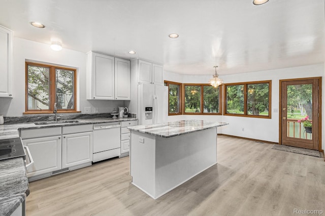 6512 White Lake Rd, Clarkston, MI 48346 - kitchen featuring dishwasher, refrigerator with ice dispenser, recessed lighting, plenty of natural light, and light wood-type flooring