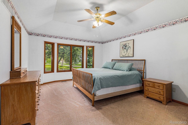 6512 White Lake Rd, Clarkston, MI 48346 - bedroom featuring light colored carpet, a tray ceiling, and a ceiling fan