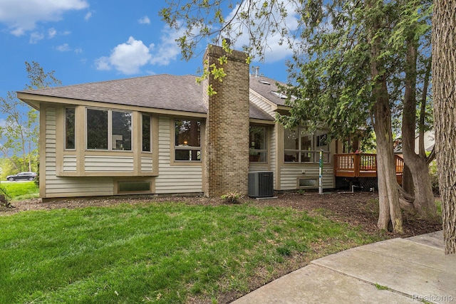 6512 White Lake Rd, Clarkston, MI 48346 - back of house featuring roof with shingles, a yard, a deck, and a chimney