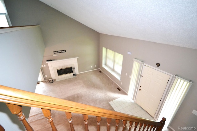 2 Cornell Ct, Dearborn, MI 48124 - carpeted foyer entrance with vaulted ceiling, a tile fireplace, and a textured ceiling