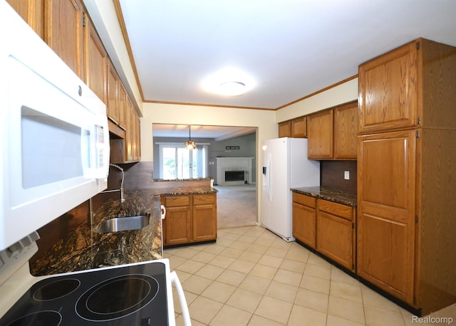2 Cornell Ct, Dearborn, MI 48124 - kitchen featuring white appliances, brown cabinetry, light tile patterned floors, ornamental molding, and a peninsula