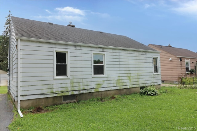3922 Hogarth Ave, Flint, MI 48532 - view of side of property featuring roof with shingles and a lawn