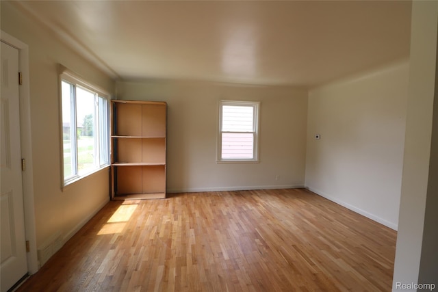 3922 Hogarth Ave, Flint, MI 48532 - spare room with healthy amount of natural light and light wood-style flooring