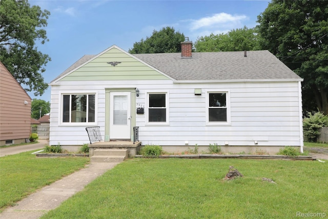 3922 Hogarth Ave, Flint, MI 48532 - view of front of property featuring a chimney, a shingled roof, and a front yard