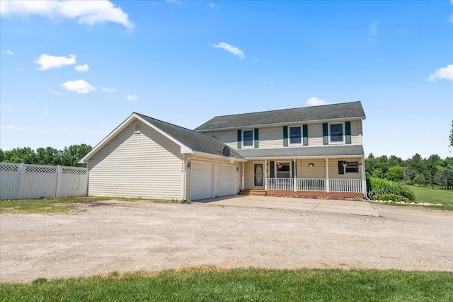 7350 N Territorial Rd, Dexter, MI 48130 - view of front facade featuring covered porch, an attached garage, and driveway