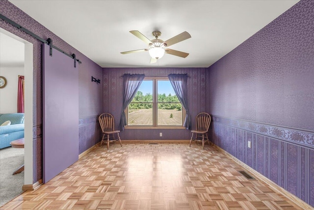 7350 N Territorial Rd, Dexter, MI 48130 - unfurnished room with wallpapered walls, ceiling fan, and a barn door
