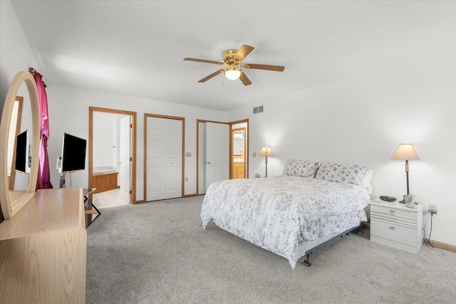 7350 N Territorial Rd, Dexter, MI 48130 - carpeted bedroom with multiple closets, connected bathroom, and a ceiling fan