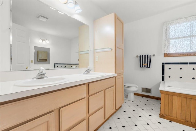 7350 N Territorial Rd, Dexter, MI 48130 - bathroom with double vanity, a bath, and tile patterned floors