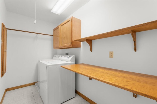 7350 N Territorial Rd, Dexter, MI 48130 - washroom featuring washing machine and dryer, cabinet space, and light tile patterned flooring