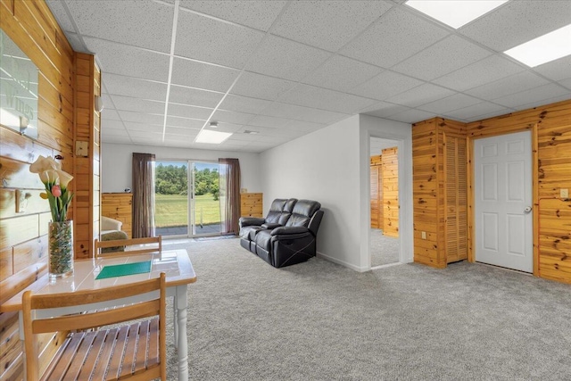7350 N Territorial Rd, Dexter, MI 48130 - carpeted living room with wooden walls and a paneled ceiling
