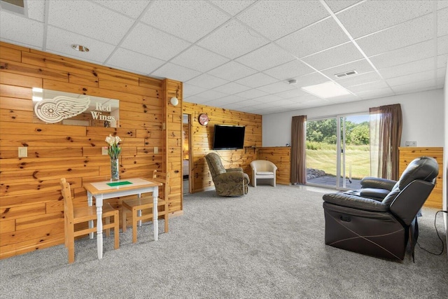 7350 N Territorial Rd, Dexter, MI 48130 - carpeted living area with wood walls and a paneled ceiling