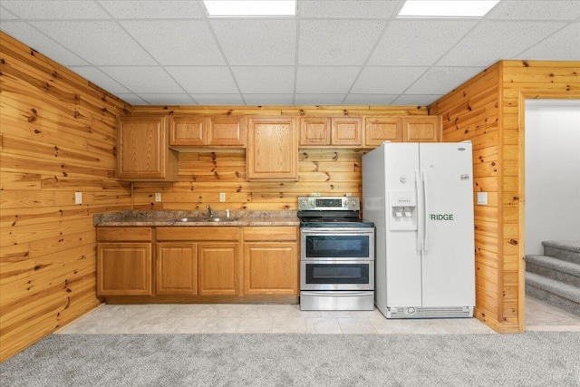 7350 N Territorial Rd, Dexter, MI 48130 - kitchen featuring white fridge with ice dispenser, double oven range, wooden walls, and light carpet