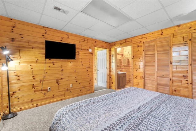 7350 N Territorial Rd, Dexter, MI 48130 - bedroom featuring carpet flooring, a paneled ceiling, wood walls, and a closet