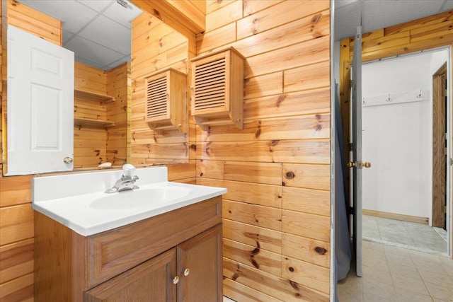7350 N Territorial Rd, Dexter, MI 48130 - bathroom with wood walls, vanity, tile patterned floors, and a paneled ceiling
