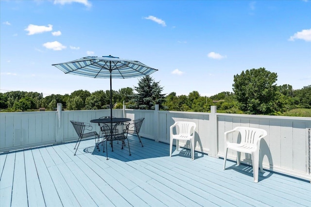 7350 N Territorial Rd, Dexter, MI 48130 - deck featuring outdoor dining area and view of wooded area