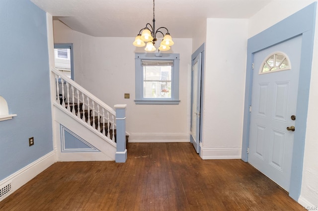 422 S Winter St, Adrian, MI 49221 - foyer entrance with wood-type flooring, a chandelier, and healthy amount of natural light