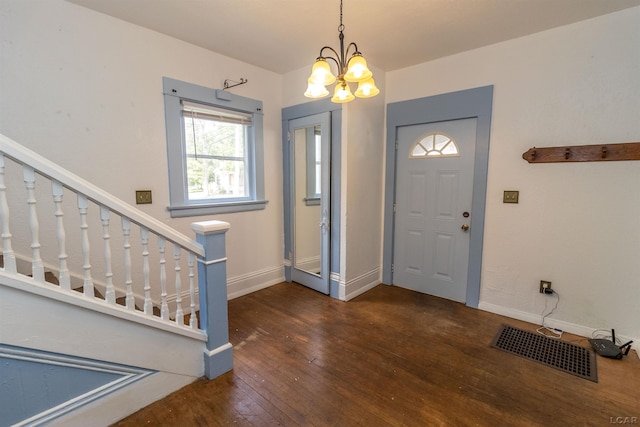 422 S Winter St, Adrian, MI 49221 - foyer entrance featuring wood-type flooring and a chandelier