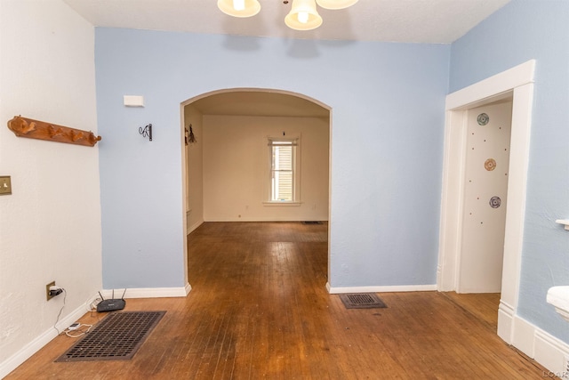 422 S Winter St, Adrian, MI 49221 - hallway featuring arched walkways and wood finished floors