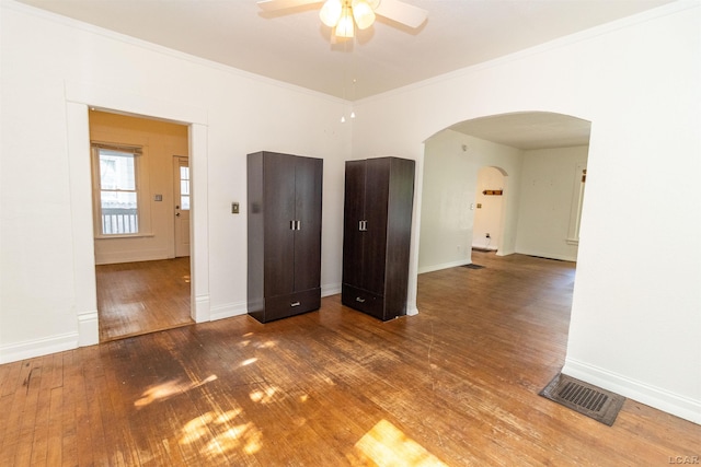 422 S Winter St, Adrian, MI 49221 - unfurnished room with arched walkways, ceiling fan, hardwood / wood-style floors, and crown molding