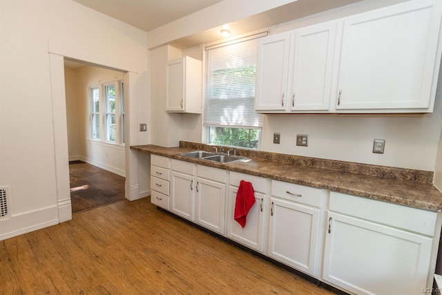 422 S Winter St, Adrian, MI 49221 - kitchen featuring light wood-style flooring, white cabinets, and dark countertops