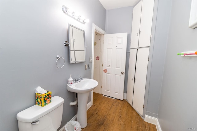 422 S Winter St, Adrian, MI 49221 - bathroom with wood finished floors and toilet