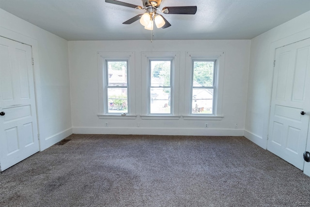 422 S Winter St, Adrian, MI 49221 - spare room featuring dark colored carpet and ceiling fan