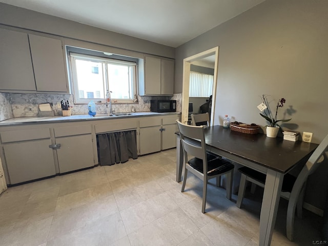 3841 Westpoint St, Dearborn, MI 48124 - kitchen with tasteful backsplash, black microwave, and gray cabinets